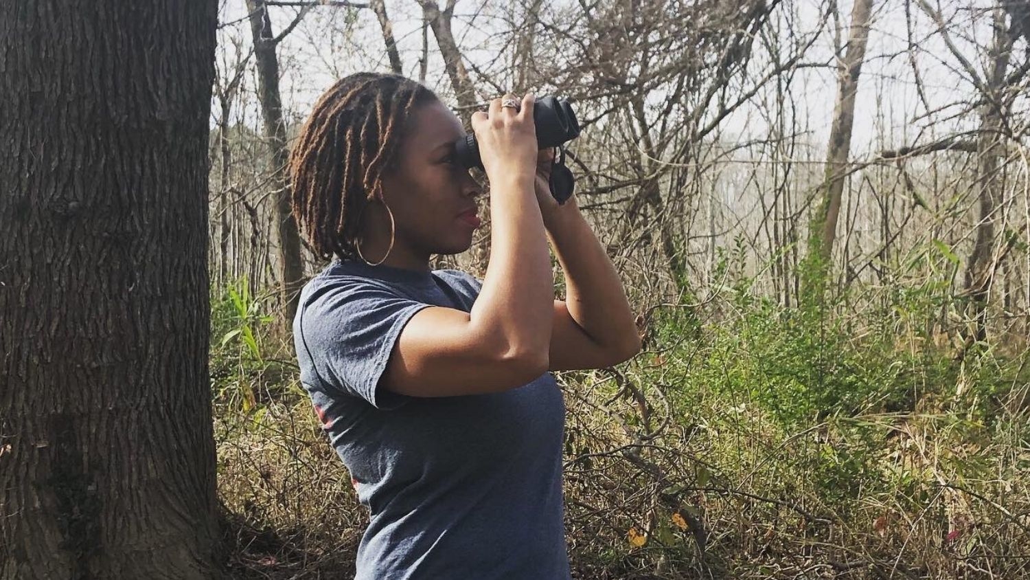 black birders week organizer deja perkins looks for birds through binoculars