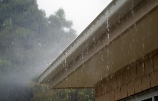 rainwater falls on rooftop rain gutter